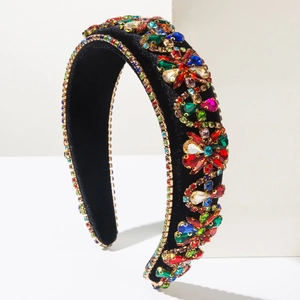 Detailed macro view of colorful rhinestones on a black velvet wide baroque headband