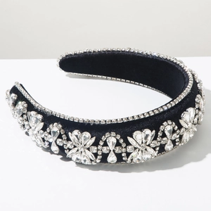 Detailed close-up of velvet headband with crystal floral patterns and rhinestone edges