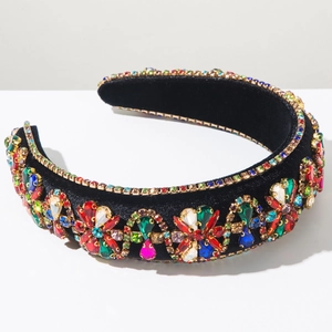 Detailed view of colorful rhinestones on a thick black velvet baroque headband for gala