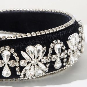 Close-up of luxury black velvet headband with sparkling crystals in floral pattern