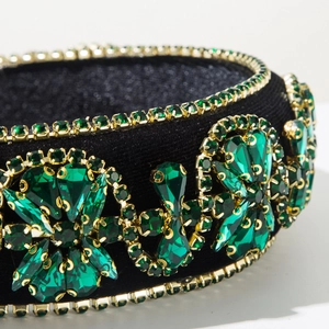 Macro shot of luxury green crystal floral vine patterns on wide velvet headband