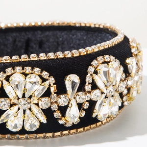 Macro shot of luxury baroque headband with clear crystals and golden claw settings