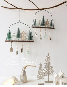 Detail of Nordic wooden Christmas house wall hanging with HOME and XMAS letter blocks