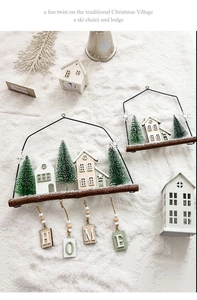 Detail of Nordic wooden Christmas house ornament with HOME sign and wire frame decor