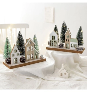 Close-up of Nordic wooden Christmas house ornament with warm LED lights and pine cones