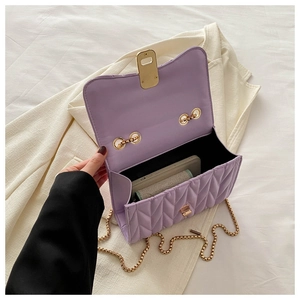 Internal view of a lavender quilted chain bag showing interior capacity for a mobile phone