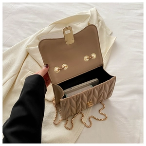 Interior view of beige quilted crossbody bag with gold chain and smartphone capacity