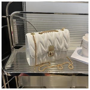 Detail of white matelassé pleated leather bag with gold chain and rectangle twist lock