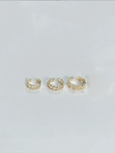 Three-piece gold hollow metal ring set featuring bohemian wave and disk chain designs