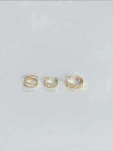 Detailed macro view of three golden open adjustable rings with geometric patterns