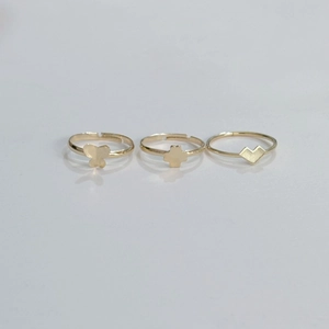 Three-piece bohemian gold metal ring set featuring butterfly, flower, and heart designs