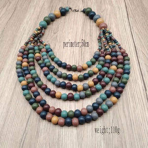 Detail view of colorful five-layer bohemian wooden bead necklace with lobster clasp