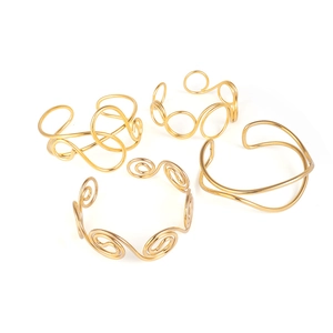 Set of four minimalist gold-plated open arm cuffs with geometric spiral and wavy designs