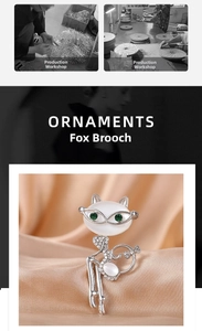 Macro detail of silver fox brooch featuring opal stone and green rhinestone eyes
