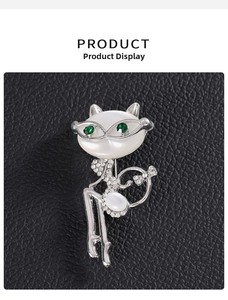 Macro shot of cute cat brooch featuring sparkling rhinestones and white pearlescent head