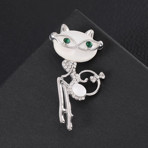 Elegant silver cat brooch with opal head and green rhinestone eyes on black background