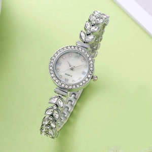 Elegant silver mermaid fashion watch with crystal leaf strap and diamond bezel on green background