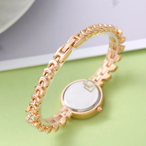 Detailed close-up of rose gold mermaid bracelet watch band with crystal accents