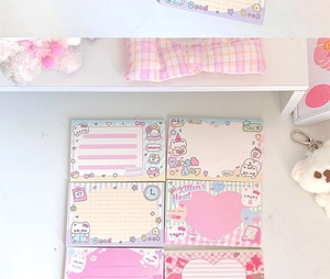 Detailed view of pastel cat themed sticky notes with cute dessert house illustrations