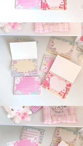 Detail of cute cat themed memo pads with ruled and grid layouts for girls