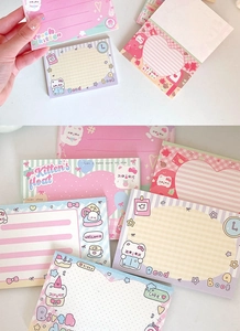 Close-up of cute cartoon cat sticky notes in pastel colors with various aesthetic designs