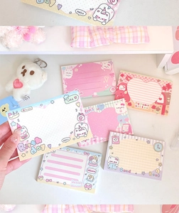 Close-up of cute cartoon cat memo notes with pastel colors and lined writing space
