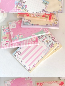 Close-up of cute cartoon cat sticky notes with various colorful pastel illustrations