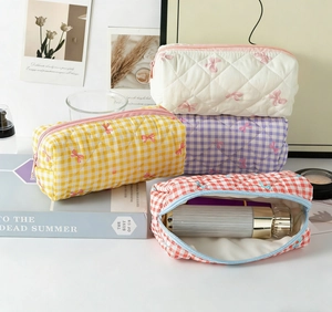 Quilted cotton cosmetic bags with bow and checkered patterns in a cozy storage scene