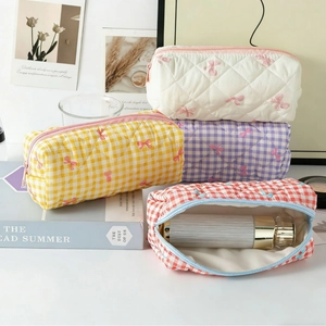 Quilted bow makeup bags in various floral prints with zipper and large storage capacity