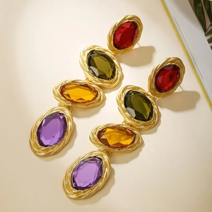Baroque style gold-tone earrings featuring colorful oval gemstones in a vertical drop design