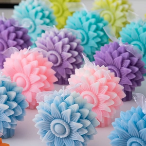 Macro detail of multi-layered flower scented candles in pastel colors with ribbon bow tie