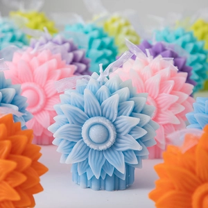 Detailed view of sunflower candles in assorted colors with decorative light ribbons