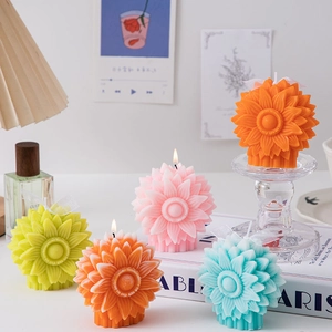Artistic sunflower scented candles in multiple colors on a book for home decor