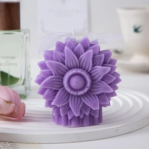 Detail of a purple sunflower scented candle with ribbon on a white decorative tray
