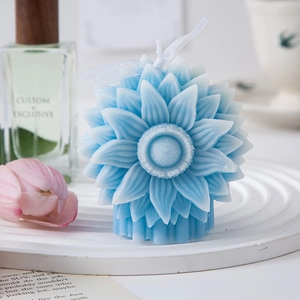 Detail of blue sunflower scented candle with ribbon on a white tray in a lifestyle setting