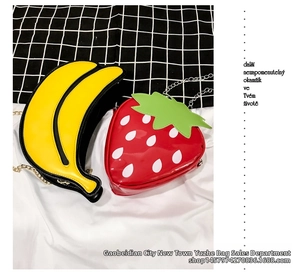 Detail of glossy fruit-shaped crossbody bags in banana and strawberry designs with metal chains