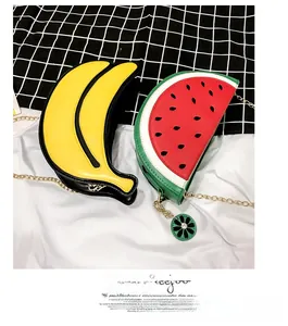 Detailed view of banana and watermelon shaped fruit bags with gold chain shoulder straps