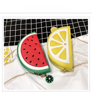 Detailed top view of watermelon and lemon shaped crossbody bags with gold chain straps