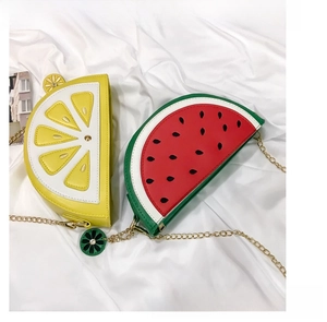 Detail of semi-circle fruit shaped crossbody bags in lemon and watermelon designs