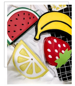 Close-up of fruit-shaped crossbody bags in watermelon, banana, lemon and strawberry styles