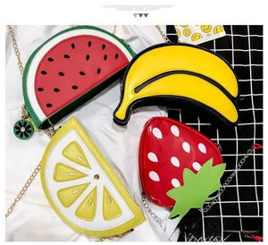 Close-up of creative watermelon, banana, and lemon fruit shaped chain crossbody bags