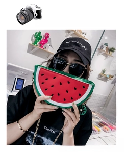 Close-up of a creative watermelon shaped crossbody bag with red and green PU details