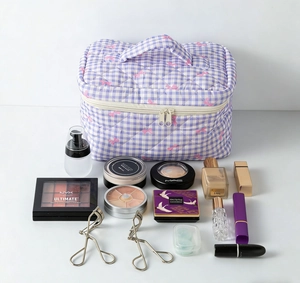 Detailed view of checkered quilted makeup bag with pink bows and top handle layout