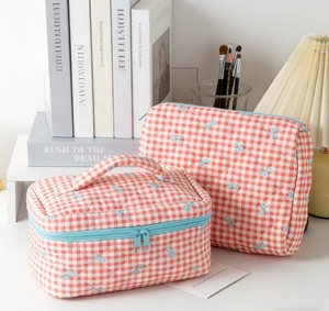 Quilted red checkered cosmetic bags set with blue bow embroidery and zipper detail