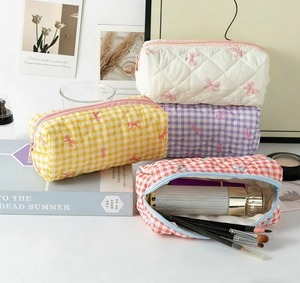 Quilted cosmetic bags with butterfly embroidery in various plaid colors and patterns