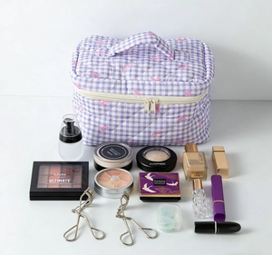 Spacious quilted makeup bag with purple checkers and bows holding cosmetics