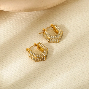Detail shot of hexagonal hoop earrings with multi-row pavé crystals in gold plating