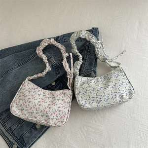 Floral canvas underarm bag with pleated strap in pink and blue summer prints