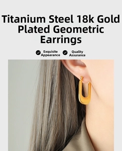 Macro detail of U-shaped gold-plated titanium earrings with brushed texture on model