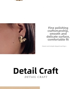 Detail of gold heart earrings featuring unique irregular fluid metal texture